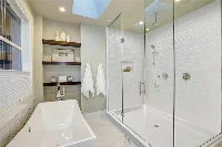 Modern corner-entry surround featuring a space-saving L-shaped panel layout designed specifically for angled, corner-access glass enclosures