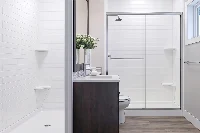 Contemporary connected shower surround with a sturdy monolithic panel design, engineered to eliminate tight gaps between the vanity cabinet and the splash zone