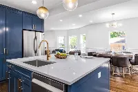 Modern full island countertop featuring an expansive, seamless surface and a clean-lined, monolithic silhouette that anchors the center of the kitchen