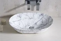 Modern round vessel sink featuring a tactile, hand-carved outer texture and a smooth interior basin