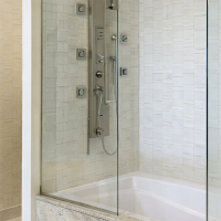 Luxury bathroom granite tub surround with sleek glass enclosure