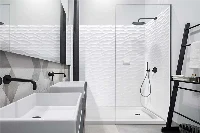 Sleek architectural glass-ready surround showcasing grout-free panels that provide a clean, high-contrast backdrop behind transparent shower walls