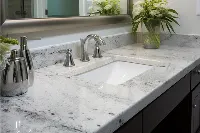 Polished granite bathroom vanity featuring two symmetrical undermount sinks and a spacious central countertop area