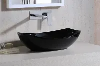 Modern round vessel sink with a sleek, thin-edged profile sitting atop a bathroom vanity