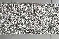 Modern fine grain surface panel featuring a high-density solid-surface build and a delicate, stippled texture that offers a sophisticated matte feel