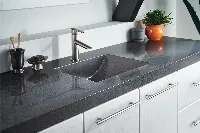 Sophisticated natural stone surface featuring a sleek, low-profile edge and a uniform salt-and-pepper grain