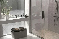 Sleek doorless-entry shower surround showcasing seamless architectural walls that easily accommodate long, splash-prone walk-in layouts