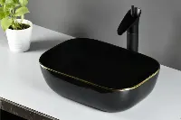 Modern square vessel sink with sharp, clean lines and a deep basin sitting atop a bathroom vanity