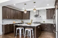 Contemporary freestanding counter with a waterfall edge design and a sturdy, monolithic silhouette that serves as a focal point