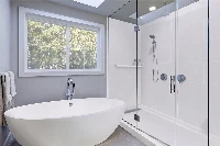 Minimalist back-to-wall surround station offering high-impact moisture protection and a clean backdrop for exposed luxury plumbing