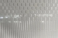 Modern vertical groove panel featuring an engineered solid-surface construction and a crisp, linear pattern that visually heightens interior spaces