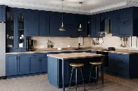 Contemporary U-shaped unit with clean-lined, handle-free doors and an expansive countertop surface for maximum prep area