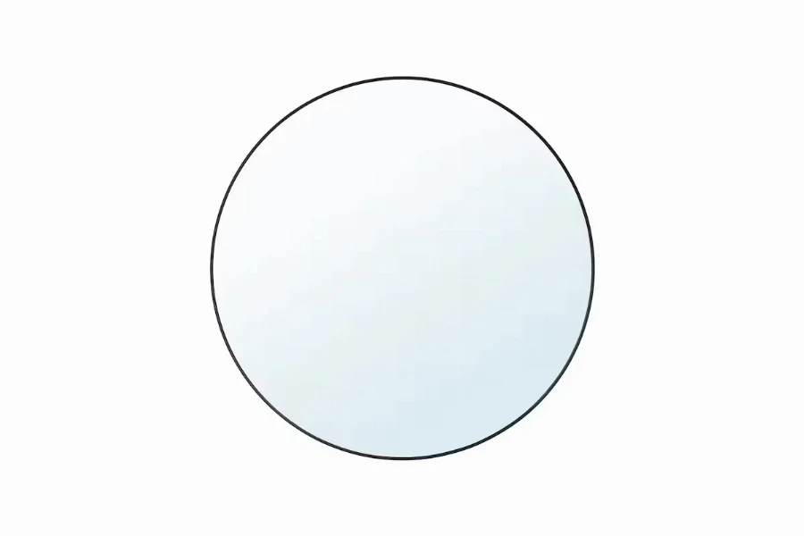 Modern minimal round mirror with a thin-profile frame for a sleek hotel bathroom aesthetic