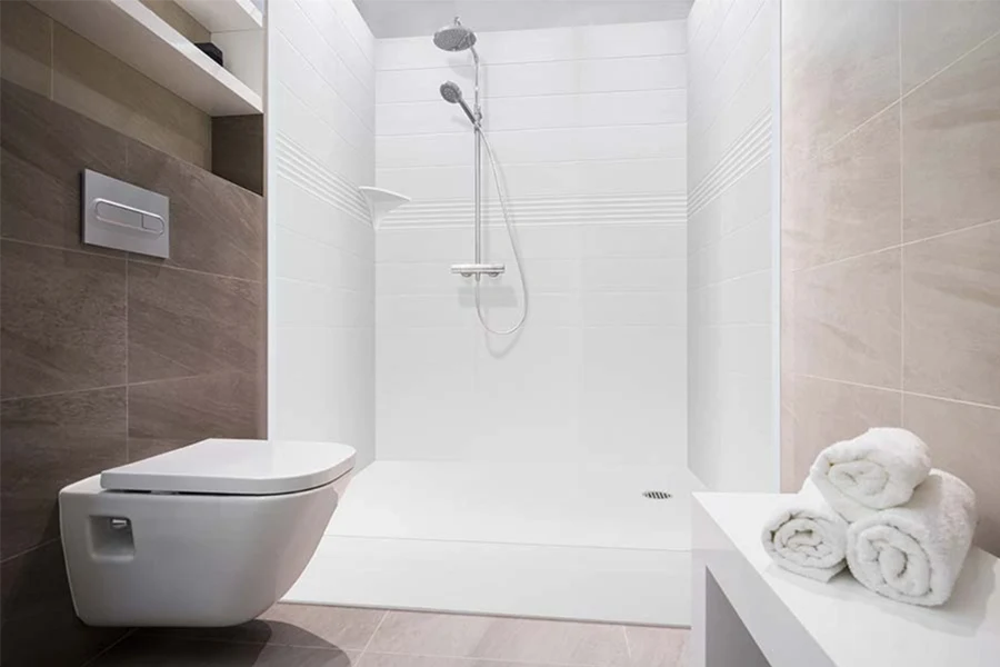 Modern compact shower surround featuring smooth, interlocking solid-surface panels and a highly functional, small-footprint design