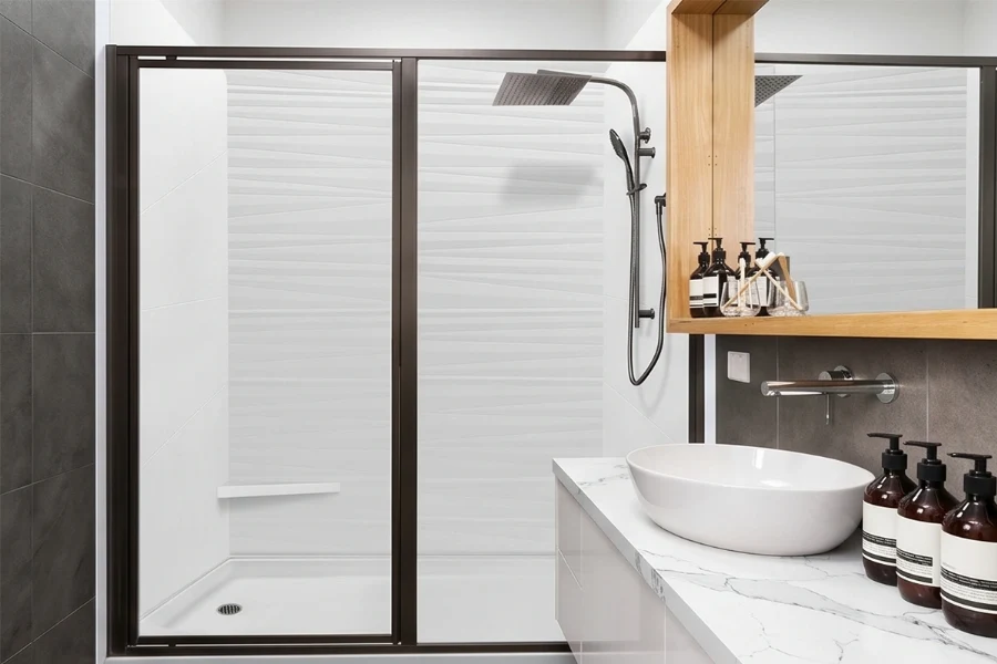 Sleek geometric alcove enclosure showcasing clean vertical lines and watertight corner joints that maximize compact showering space