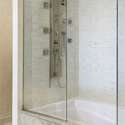 Luxury bathroom granite tub surround with sleek glass enclosure