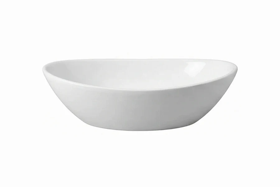 Sleek oval washbasin designed to sit atop a vanity, featuring a traditional silhouette and smooth edges