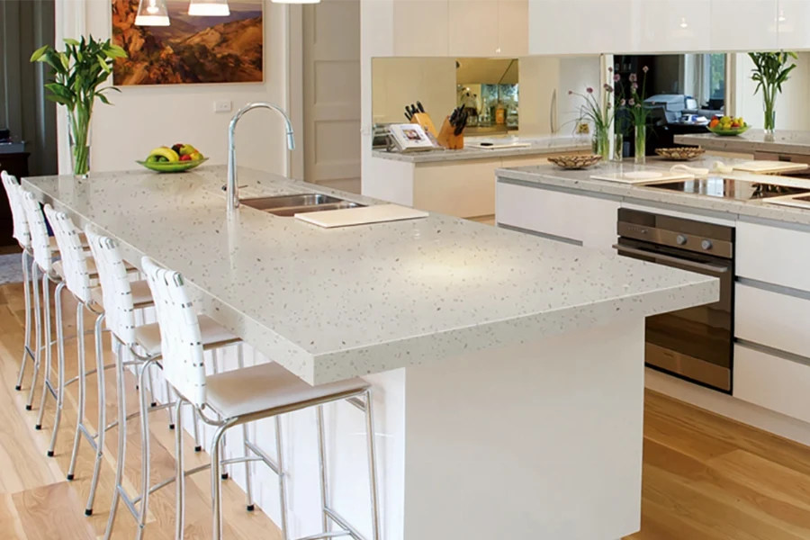 Modern multi-level island countertop featuring a tiered dual-height surface that seamlessly separates food preparation zones from casual dining spaces