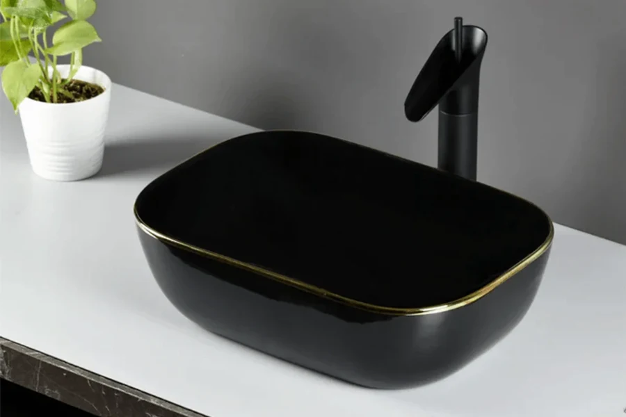 Modern square vessel sink with sharp, clean lines and a deep basin sitting atop a bathroom vanity