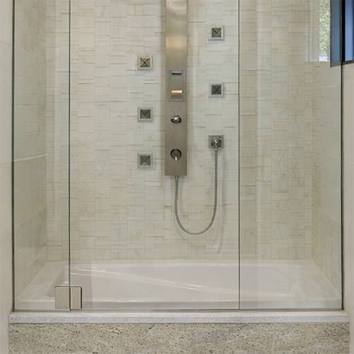 High-quality granite tub surround with glass enclosure for hotels