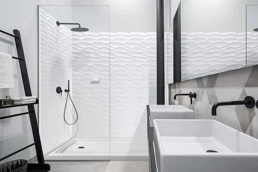Modern glass enclosure surround featuring seamless solid-surface wall panels engineered to pair perfectly with minimalist, frameless glass hardware