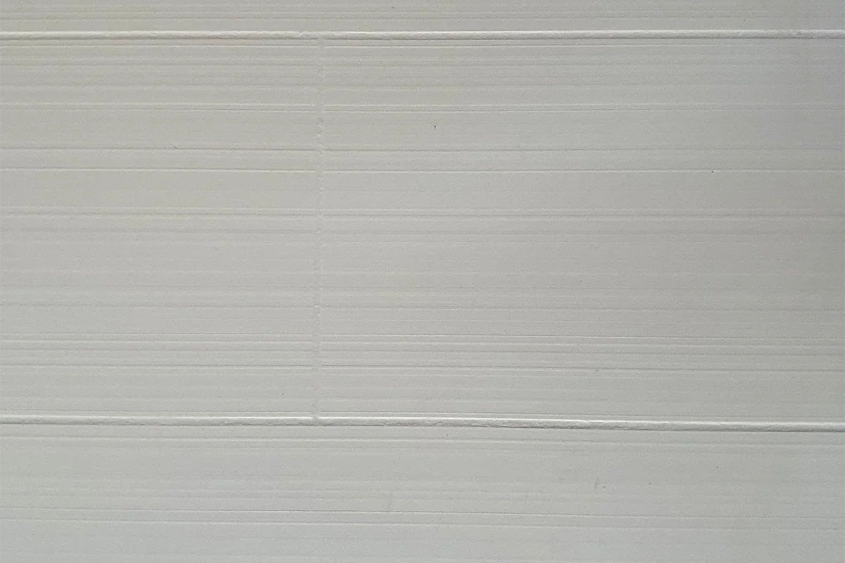 Modern horizontal line panel featuring an engineered solid-surface construction and a crisp, linear pattern that visually expands interior spaces