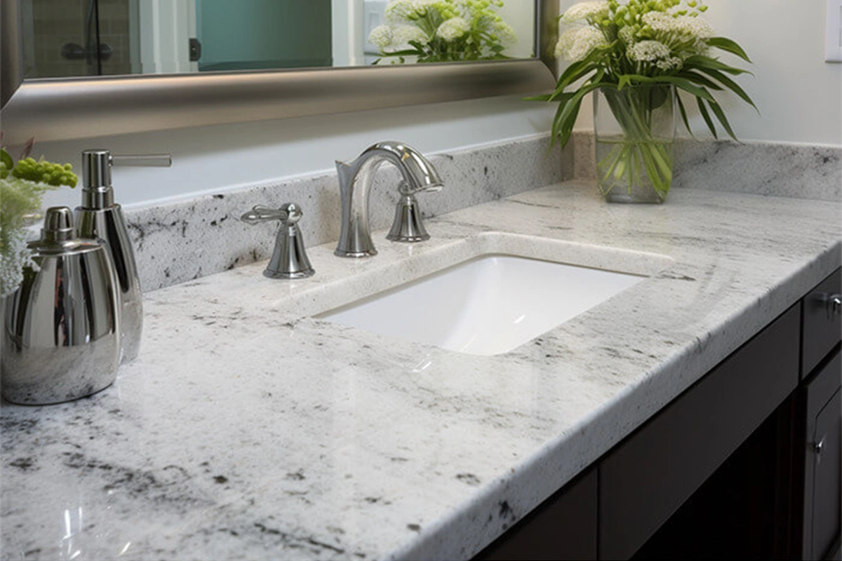 Polished granite bathroom vanity featuring two symmetrical undermount sinks and a spacious central countertop area
