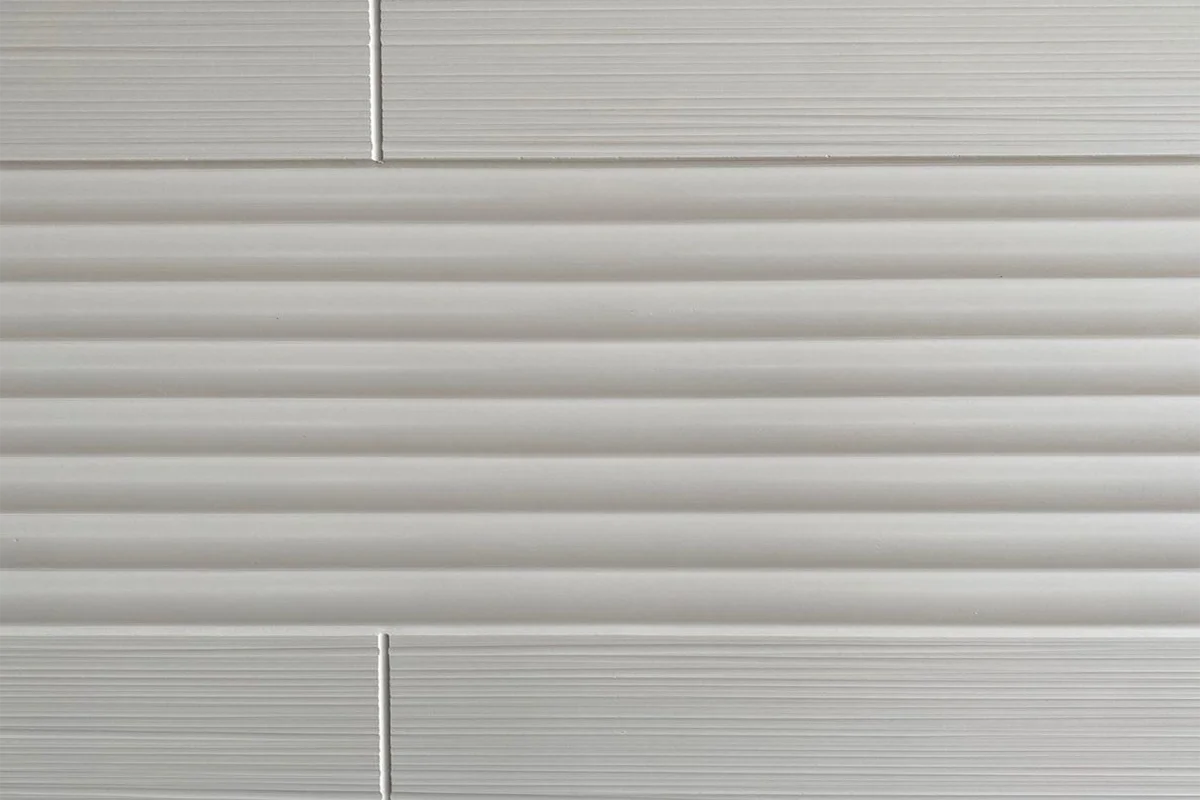 A cultured marble wall panel designed for hotel shower enclosures, boutique suite bathroom walls, and hospitality wet room installations - where a vertically ribbed surface adds tactile and visual depth to the shower wall.