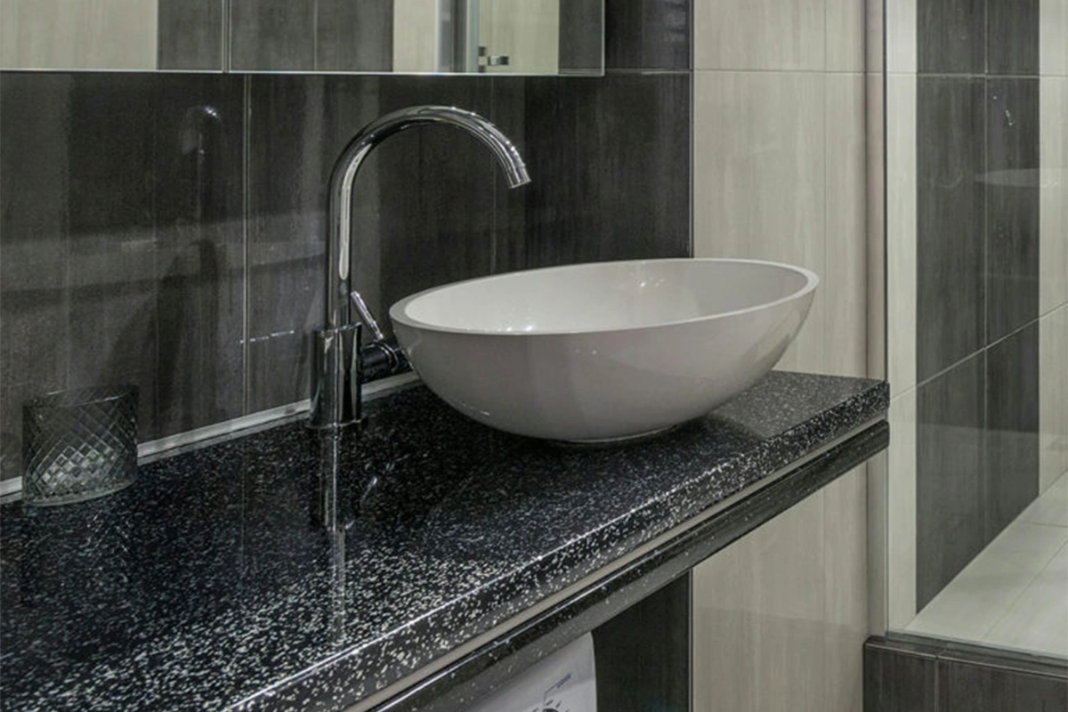 Modern granite vanity surface featuring a flat, solid deck designed specifically for a contemporary vessel sink installation