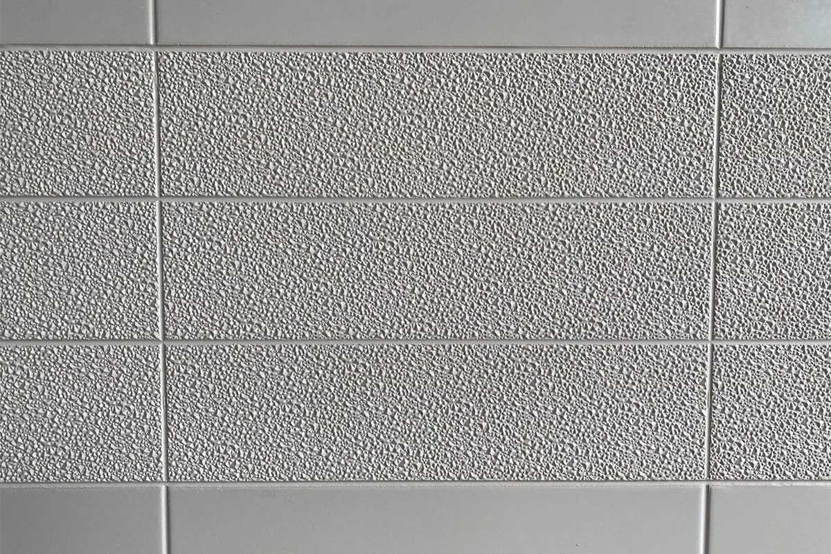 Modern fine grain surface panel featuring a high-density solid-surface build and a delicate, stippled texture that offers a sophisticated matte feel