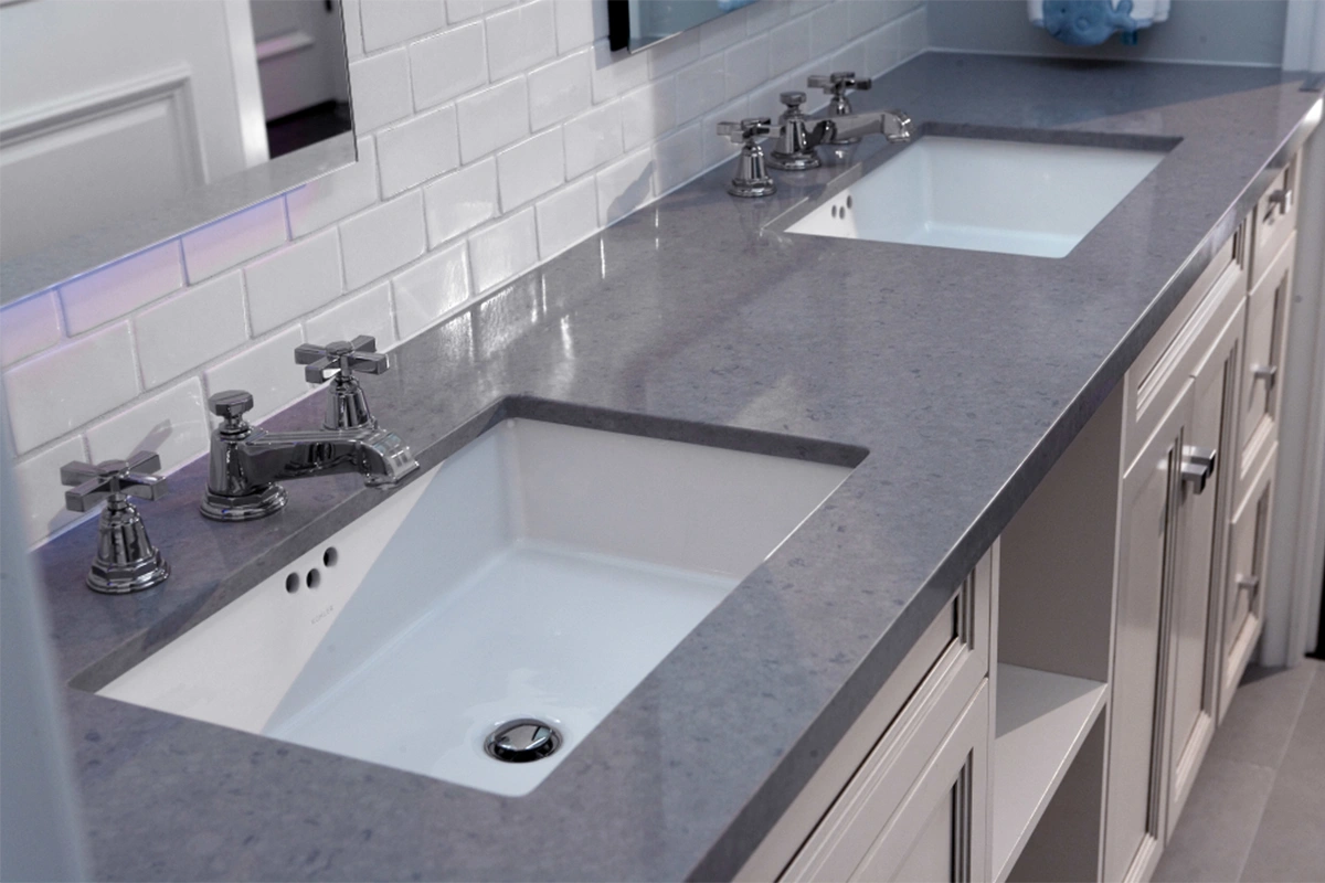 Modern dual-sink vanity surface with two symmetrical undermount basins and a sleek, low-profile stone edge