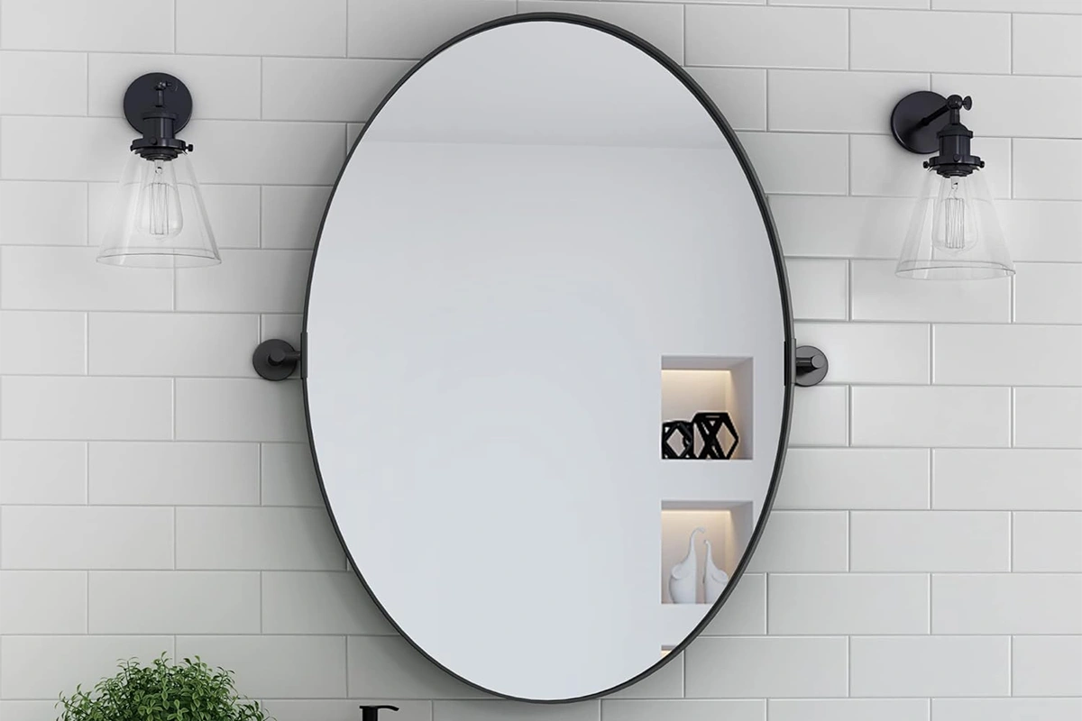 Modern oval wall mirror with a sleek, minimalist frame for hotel suites