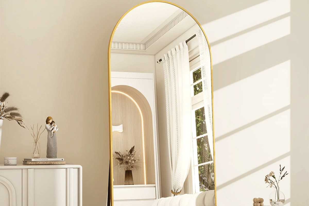 Modern arched floor mirror with a sleek metal frame for hotel suites
