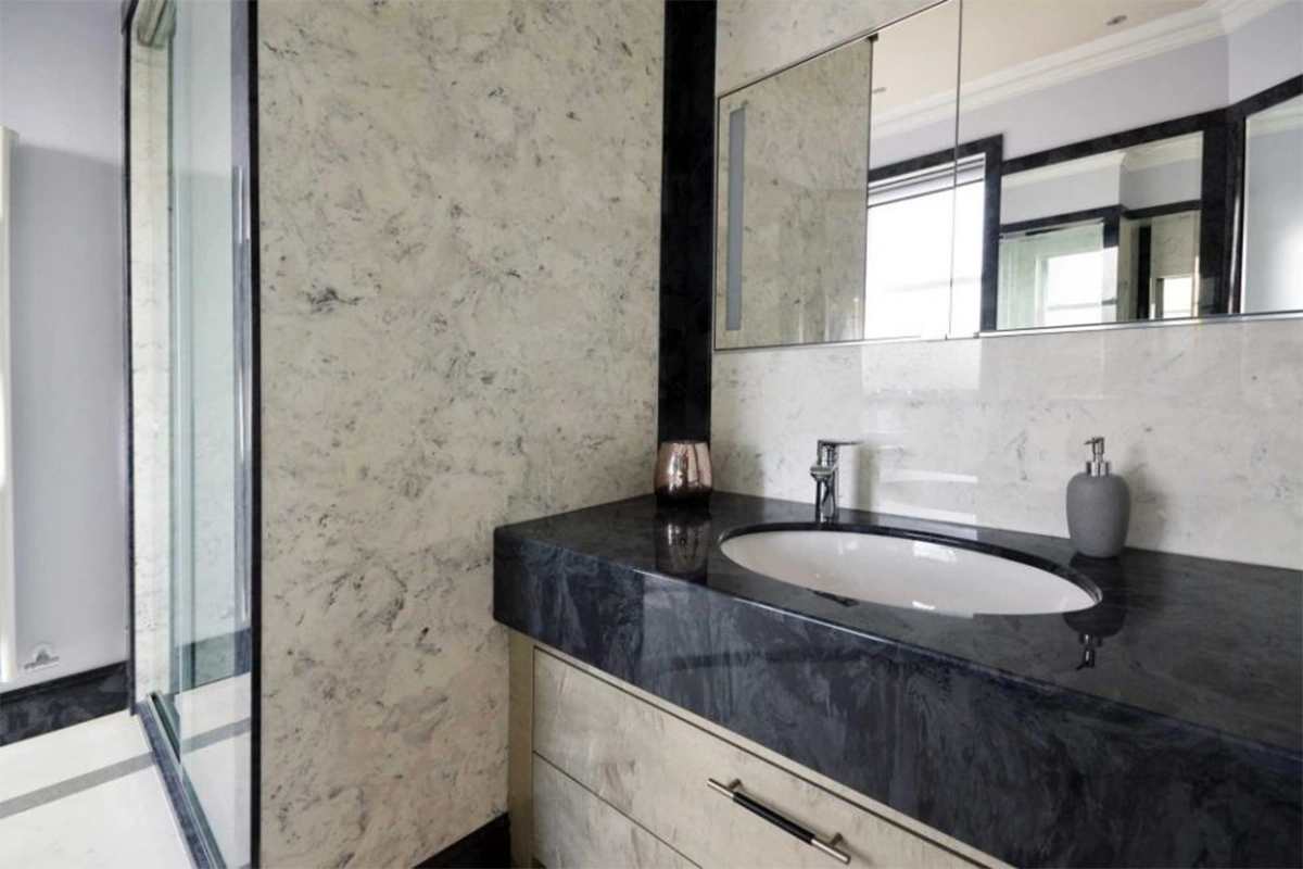 Modern wall-mounted granite vanity top featuring a thick, structural profile and a seamless, cantilevered appearance