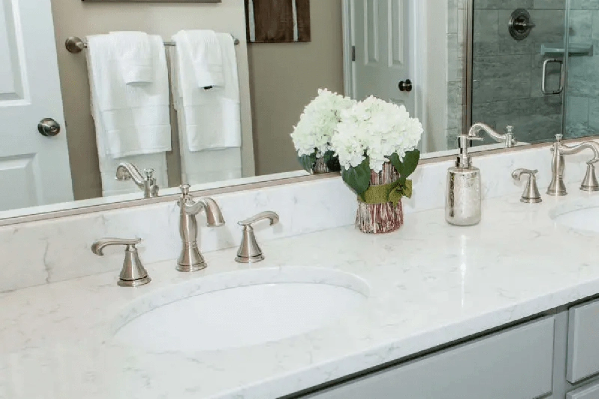 Luxury designer granite vanity surface featuring a dramatic mitered apron edge and a custom-polished natural stone grain