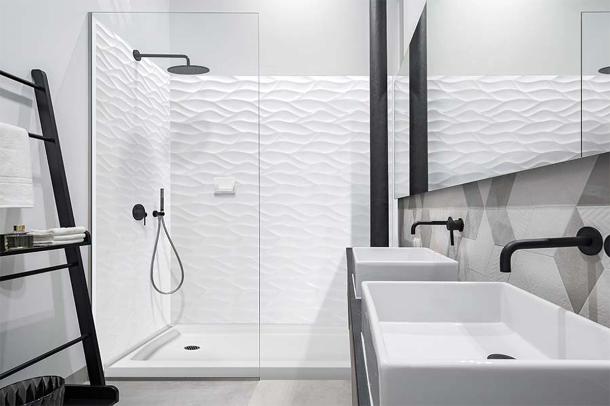 Modern glass enclosure surround featuring seamless solid-surface wall panels engineered to pair perfectly with minimalist, frameless glass hardware