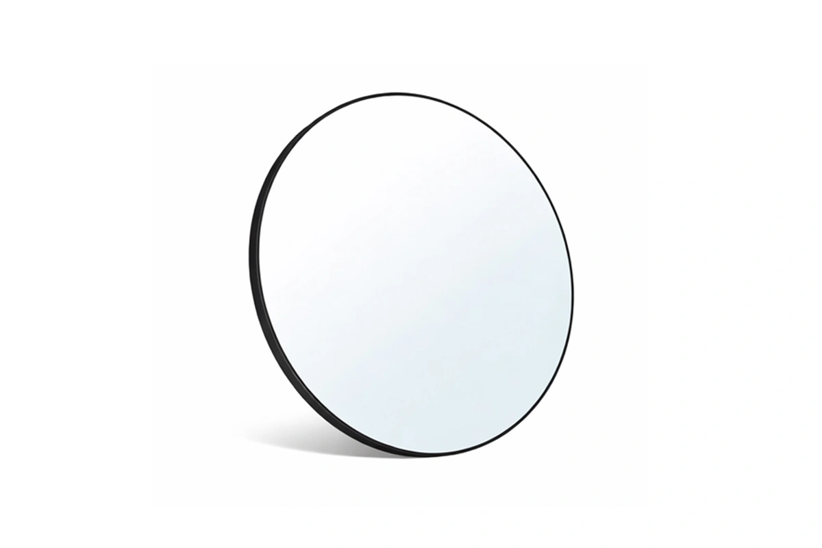 Sleek hospitality-grade circular wall mirror designed for minimalist boutique hotel suites